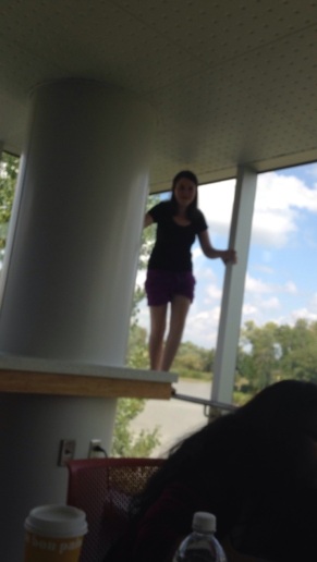 Rachel in her natural habitat (standing on safety bars is a hobby of hers). It's a little blurry but this is the kitchen/lounge right across from our room. As you can see there is another lovely view of the lake (which I love, clearly).