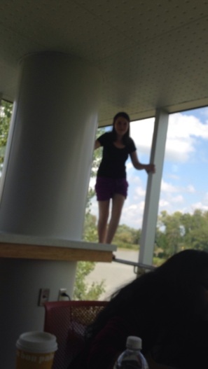 Rachel in her natural habitat (standing on safety bars is a hobby of hers). It's a little blurry but this is the kitchen/lounge right across from our room. As you can see there is another lovely view of the lake (which I love, clearly).